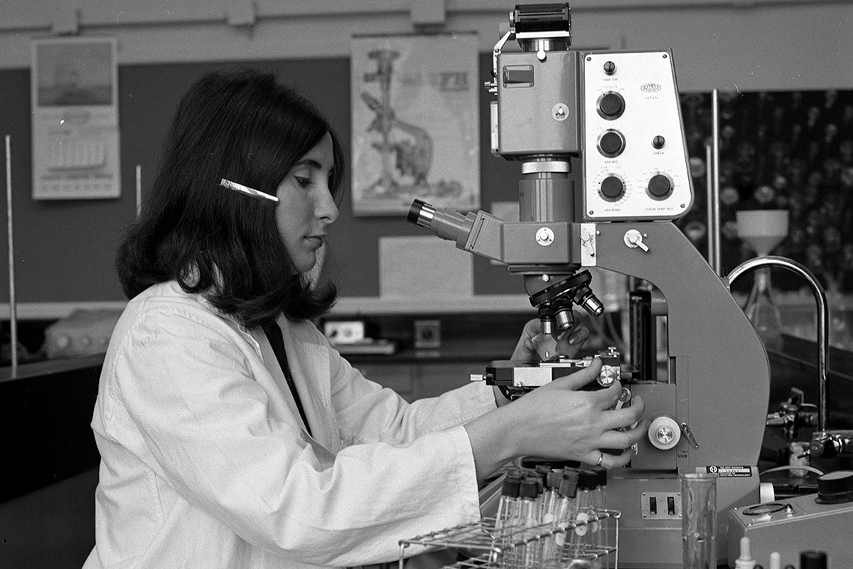 Lab Technician student using a microscope